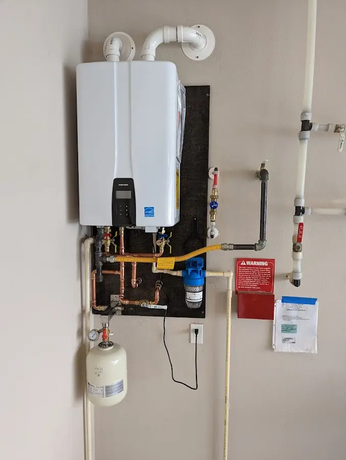 Professional plumber installing copper piping in a Gloversville home